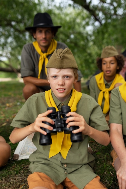 Front view smiley kid with binoculars