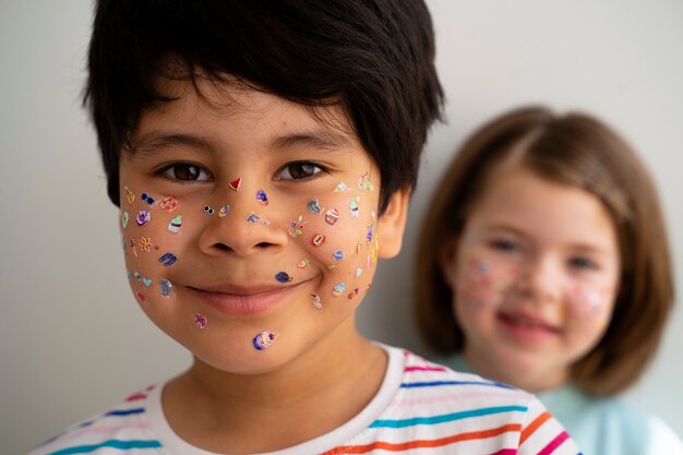 Front view smiley kids with stickers on face