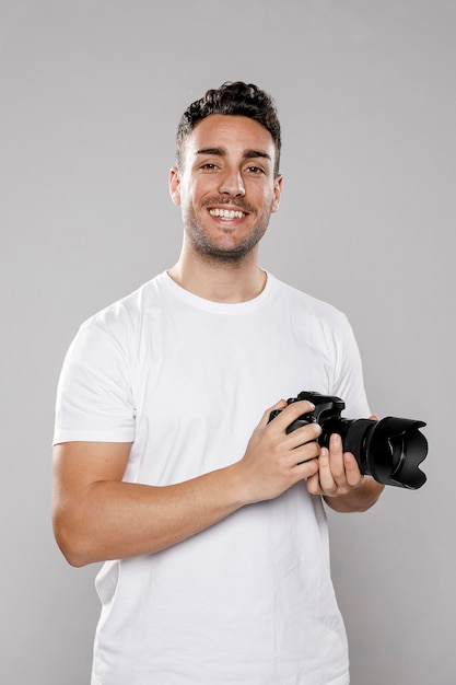 Front view of smiley male photographer