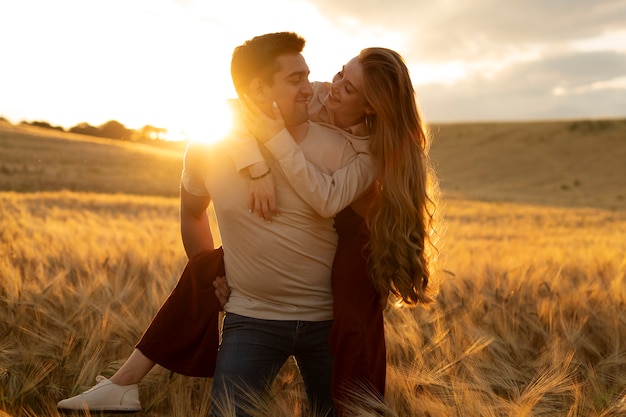 Front view smiley man carrying woman