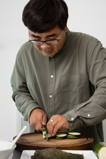 Front view smiley man cutting vegetables