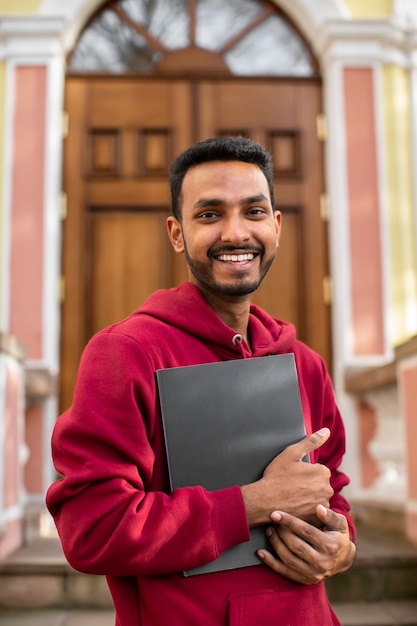 Front view smiley man holding book