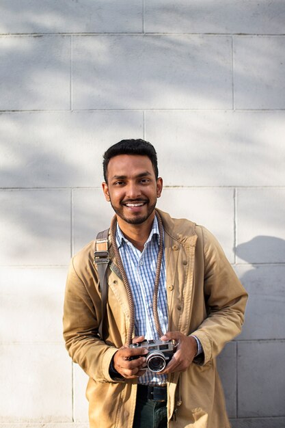 Front view smiley man holding camera