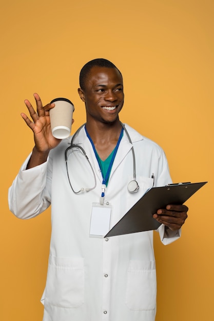 Free photo front view smiley man holding coffee cup