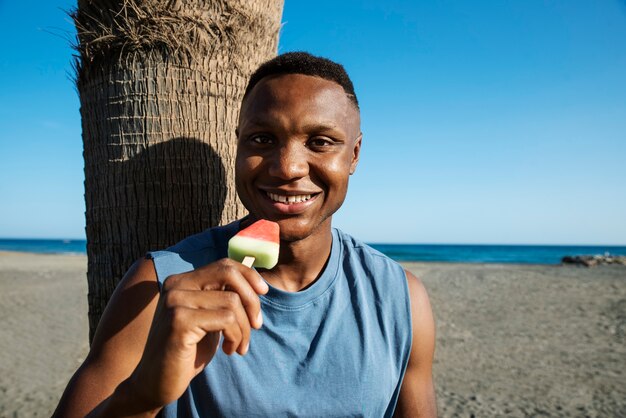 Front view smiley man holding ice cream