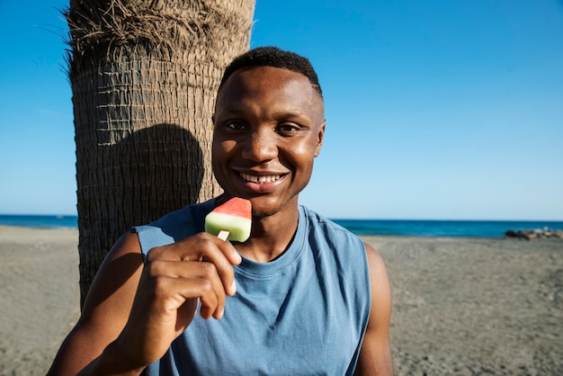 Front view smiley man holding ice cream