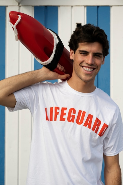 Front view smiley man holding lifesaving buoy