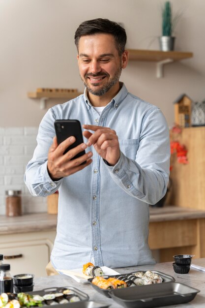 Front view smiley man holding smartphone