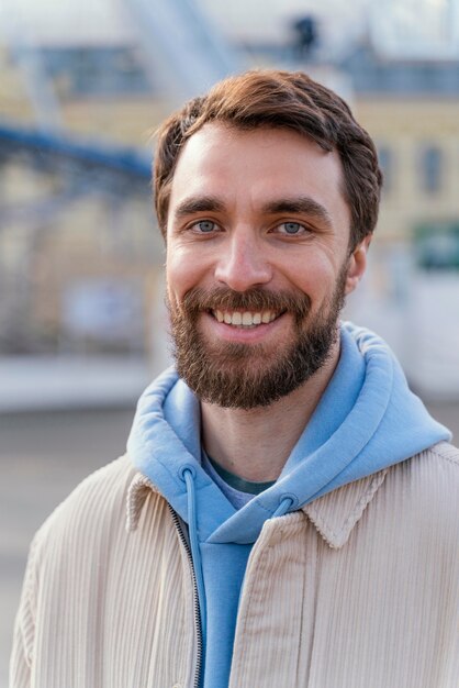 Front view of smiley man outdoors in the city