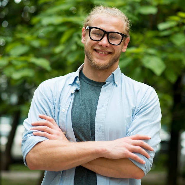 Front view of smiley man posing outdoors