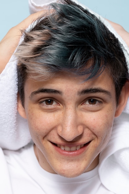 front view smiley man using towel