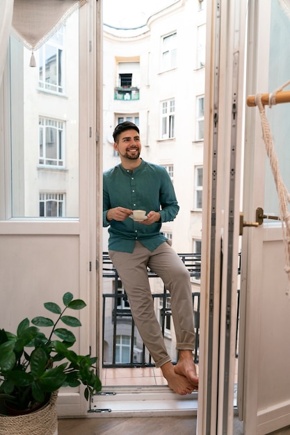 Free photo front view smiley man with coffee cup