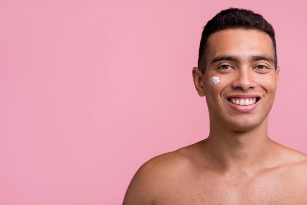 Front view of smiley man with cream on his face