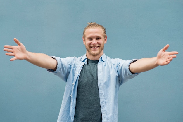 Front view of smiley man with open arms