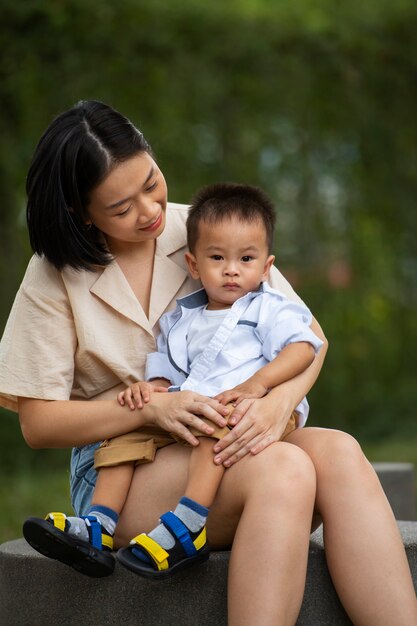 Front view smiley mother holding boy