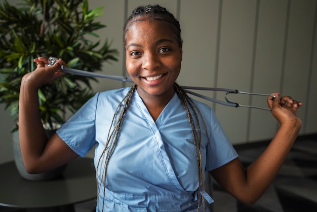 Free photo front view smiley nurse with stethoscope