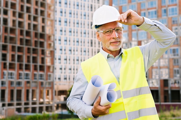 Free photo front view smiley old man with yellow neon vest