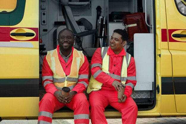 Front view smiley paramedics with coffee cups