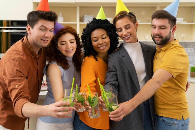 Free photo front view smiley people holding drinks