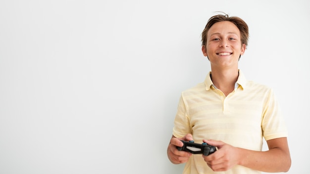 Free photo front view smiley teen holding a controller