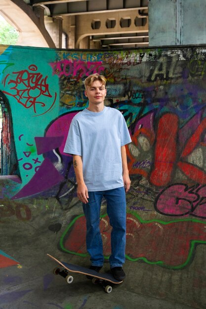 Front view smiley teen with skateboard