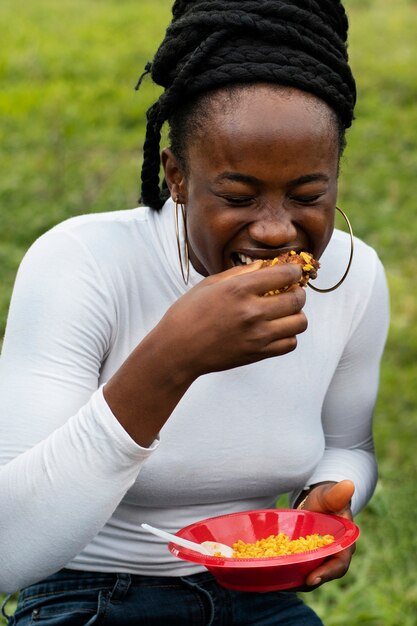 Front view smiley woman eating lunch