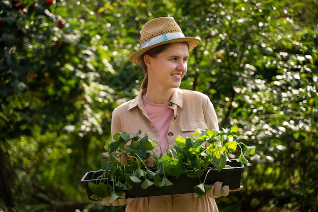 Free photo front view smiley woman farming