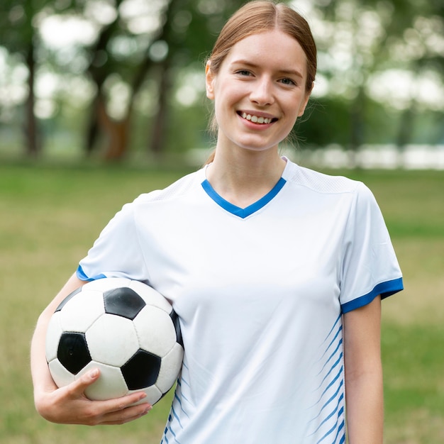 Free photo front view smiley woman holding ball