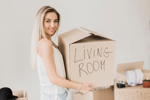 Free photo front view smiley woman holding box