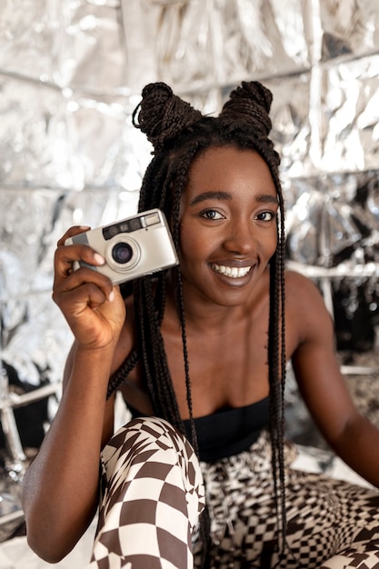 Front view smiley woman holding camera