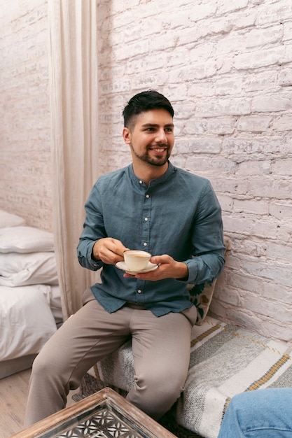 Front view smiley woman holding coffee cup