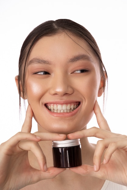 Front view smiley woman holding container