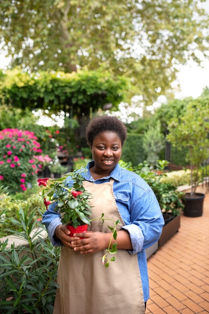 Front view smiley woman holding flowers