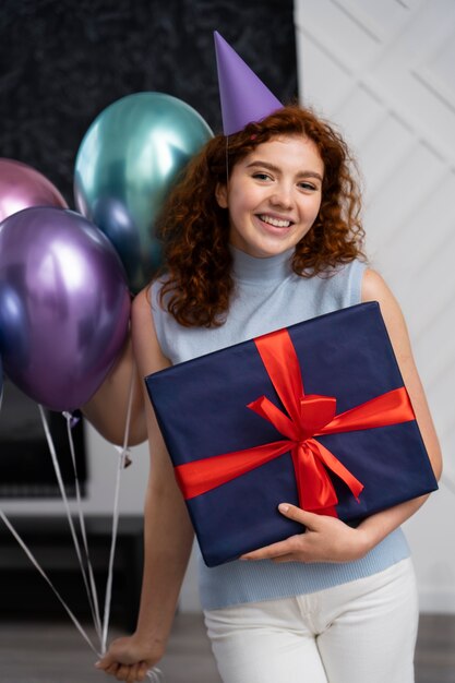 Free photo front view smiley woman holding gift