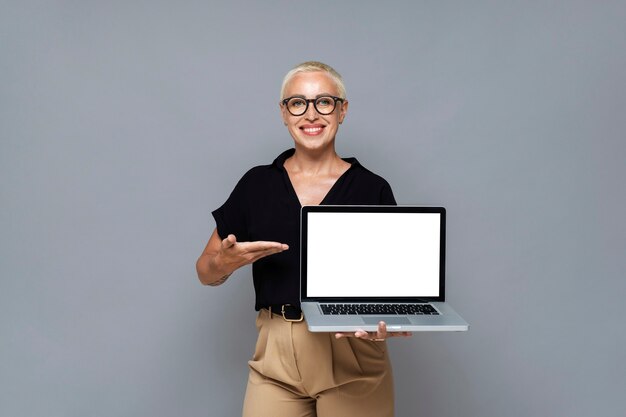 Front view smiley woman holding laptop