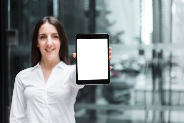 Front view smiley woman holding up a tablet