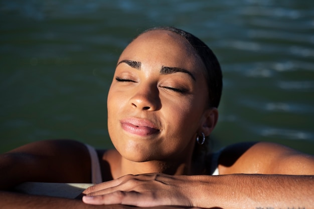 Free photo front view smiley woman in lake