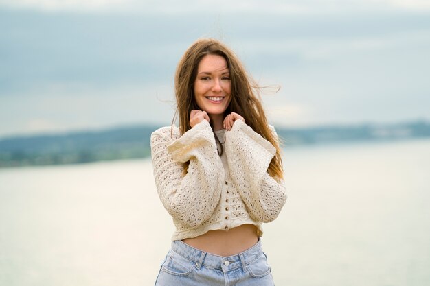 Front view smiley woman posing outdoors