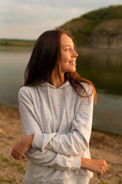 Front view smiley woman posing outdoors