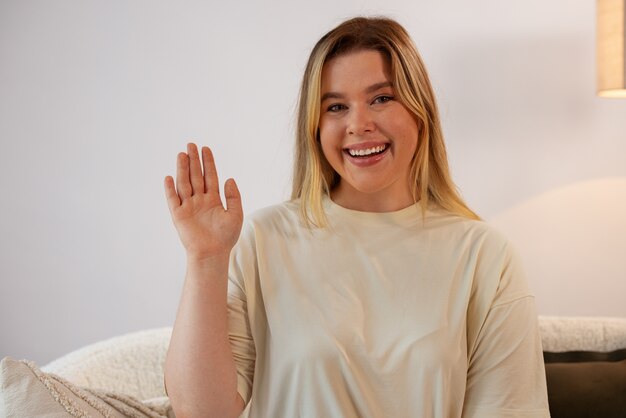 Free photo front view smiley woman saluting