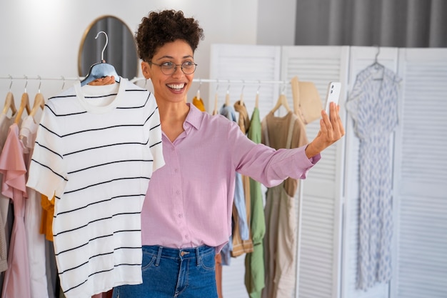 Front view smiley woman selling clothes