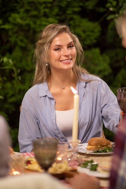 Front view smiley woman sitting at table