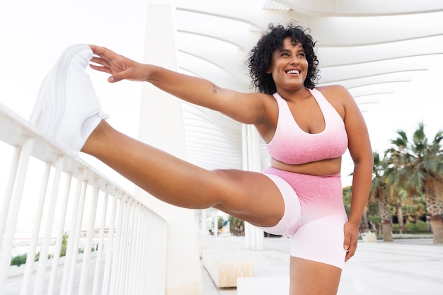 Free photo front view smiley woman stretching