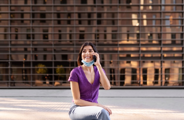 Free photo front view smiley woman talking on phone