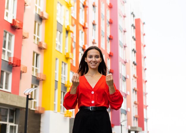 Front view of smiley woman using sign language