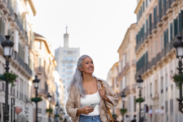 Front view smiley woman walking in city