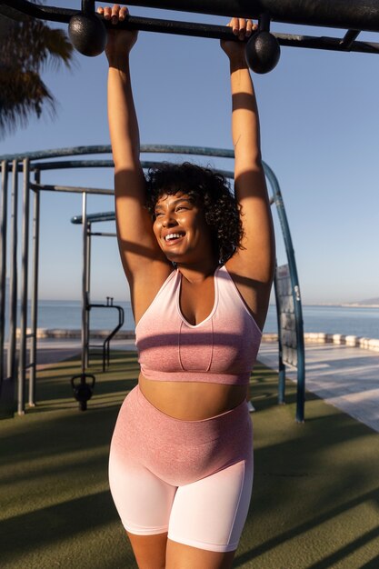 Front view smiley woman wearing sporty clothes