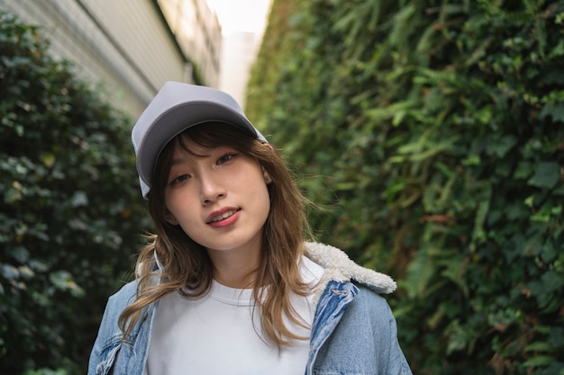 Front view smiley woman wearing trucker hat