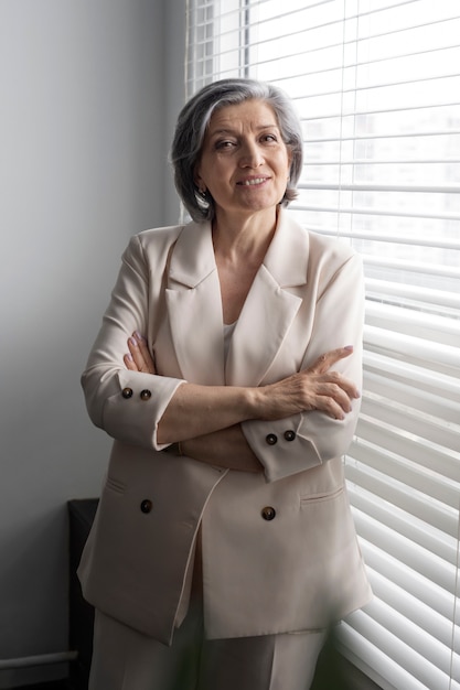 Free photo front view smiley woman with crossed arms