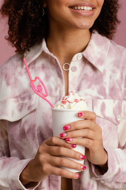 Front view of smiley woman with frappe